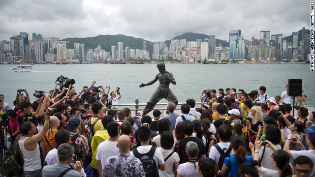 Fans gather around a statue of Bruce Lee in Hong Kong to mark the 40th anniversary of his death on July 20, 2013. Hailed as cinema's first martial arts hero and a cinematic bridge between the cultures of East and West, Bruce Lee helped put Hong Kong on the world movie map.