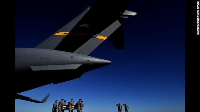 <strong>January 19:</strong> U.S. Army soldiers in Dover, Delaware, carry the flag-draped transfer case of Army Sgt. David J. Chambers, who was killed in Afghanistan.