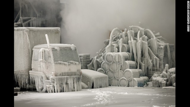 <strong>January 23:</strong> A truck is covered in ice as firefighters extinguish a massive blaze at a vacant warehouse in Chicago.