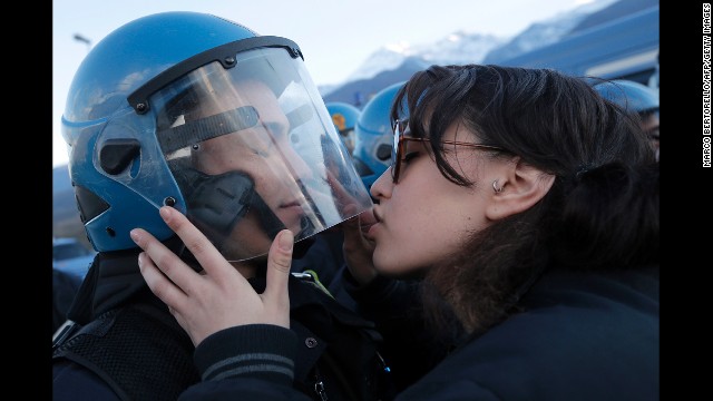 <strong>November 16:</strong> A woman kisses a police officer during a protest of a high-speed train line in Susa, Italy.