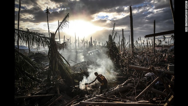 <strong>November 19:</strong> A man fans flames in Tanauan, Philippines, a week after Typhoon Haiyan ripped through the country. Haiyan, one of the strongest storms in recorded history, left thousands dead and many more homeless.