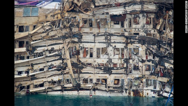 <strong>September 17:</strong> The severely damaged side of the Costa Concordia is visible after it was successfully lifted upright in Isola del Giglio, Italy. The cruise ship capsized last year.