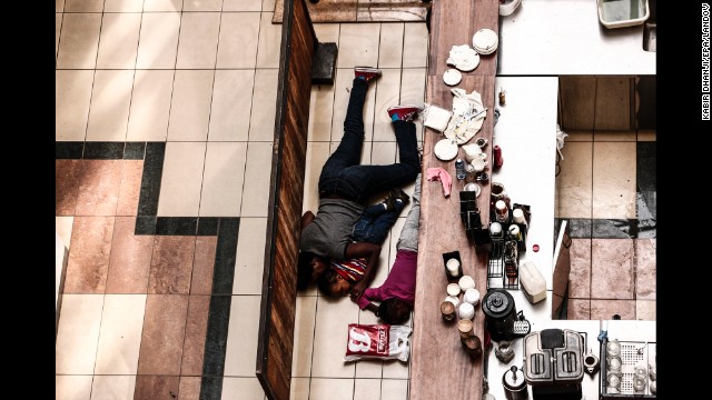 <strong>September 21:</strong> People take cover behind a counter at the Westgate shopping mall after a shootout in Nairobi, Kenya. The Somali terror group Al-Shabaab, an affiliate of al Qaeda, claimed responsibility for a bloody four-day siege at the upscale mall. At least 67 people were killed.