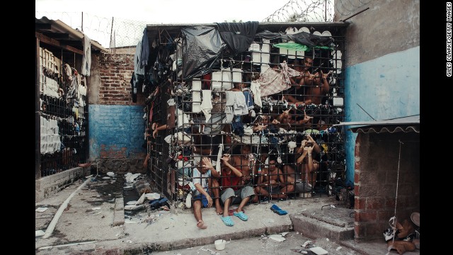 <strong>May 20:</strong> MS-13 gang members languish in one of the three overcrowded "gang cages" in the Quezaltepeque police station in San Salvador, El Salvador. Initially, the cages were designed to be 72-hour holding cells for common criminals and two rival gangs, but many individuals had been imprisoned for more than a year.