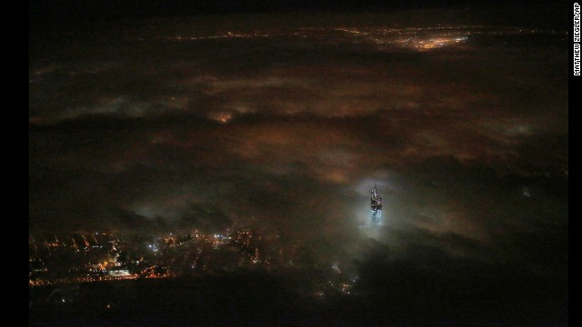 <strong>March 11:</strong> The One World Trade Center building emerges from the clouds in New York's night sky. Construction on the office complex, which is going up on the site of the original World Trade Center, is set to be completed in early 2014.