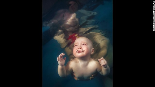 <strong>March 13:</strong> A baby is helped to swim in Kiev, Ukraine.