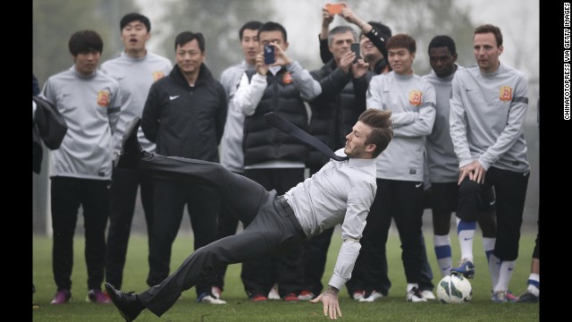 <strong>March 23:</strong> Soccer star David Beckham falls during a visit with Wuhan Zall, a professional team in Wuhan, China.