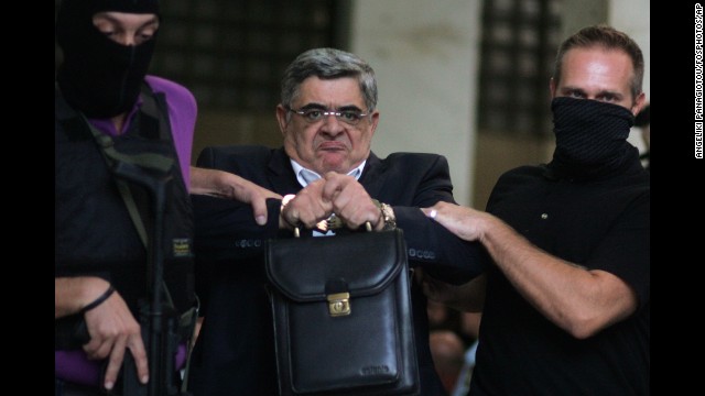 <strong>September 28:</strong> Nikos Michaloliakos, leader of the extreme-right Golden Dawn party, is escorted from police headquarters in Athens, Greece. He faces charges of running a criminal organization following the slaying of an anti-fascist musician.