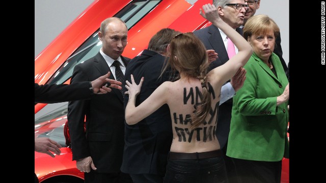 <strong>April 8:</strong> Russian President Vladimir Putin is attacked by an activist of the Ukrainian women rights group Femen as German Chancellor Angela Merkel looks on in Hannover, Germany.