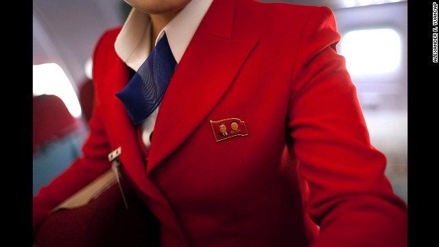 <strong>April 11:</strong> An Air Koryo attendant wears a pin showing portraits of the late North Korean leaders Kim Il Sung and Kim Jong Il. Air Koryo is the world's only 1-star airline on Skytrax, a consultancy that has ratings and reviews for more than 681 airlines.