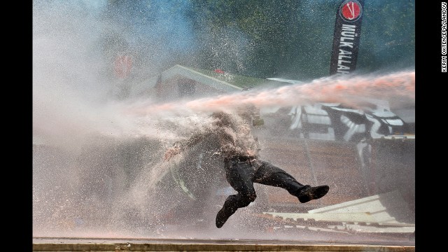 <strong>June 11:</strong> A protester is hit by a water cannon during clashes in Taksim Square in Istanbul.