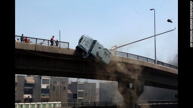 <strong>August 14:</strong> A police vehicle is pushed off the 6th October Bridge in Cairo by supporters of ousted Egyptian President Mohamed Morsy.