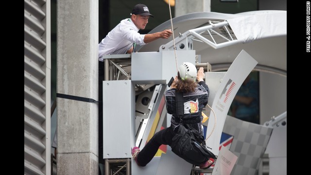 <strong>August 25:</strong> A man threatens to cut the rope of a Greenpeace protester at the Belgian Grand Prix in Spa, Belgium.