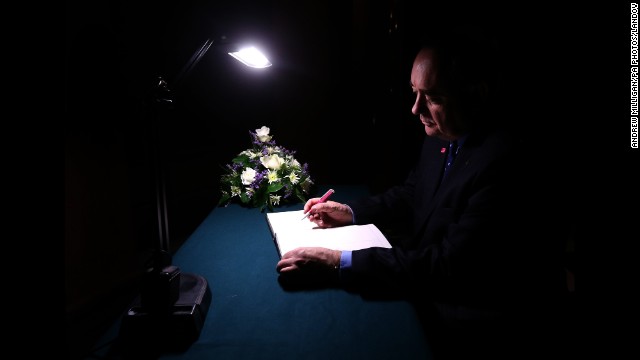 <strong>December 3:</strong> Scottish First Minister Alex Salmond signs a book of condolence at Glasgow City Chambers for those who died when a police helicopter crashed into a busy pub in Glasgow, Scotland. At least nine people were killed and 14 were seriously injured.