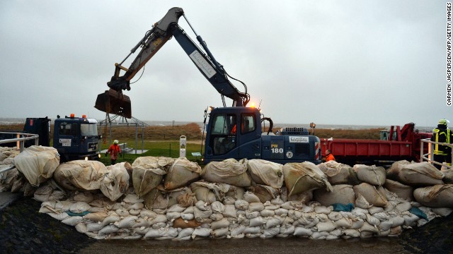 Firefighters fortify an embankment in Cuxhaven-Sahlenburg, Germany, on December 5.