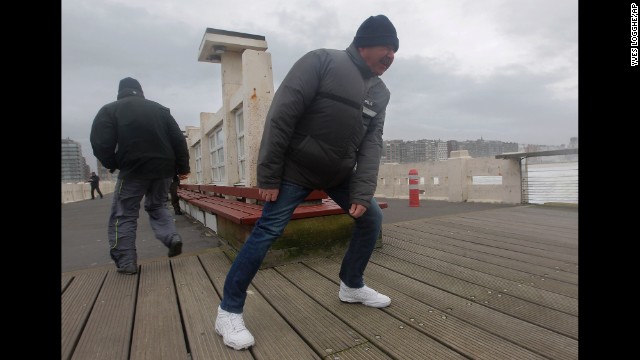 People fight against strong winds on a pier in Blankenberge, Belgium, on December 5.