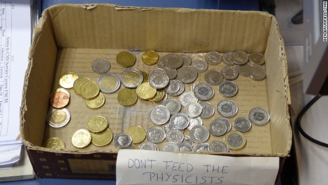 "Don't feed the physicists" marks a box of coins where CMS scientists deposit change to pay for coffee. 
