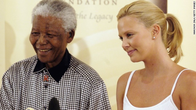 Actress Charlize Theron stands with Nelson Mandela in Johannesburg following her Academy Awards success in 2004.