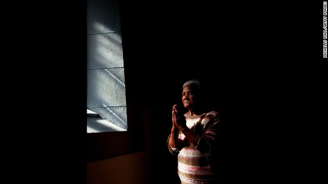 A woman prays at the Central Methodist Church as people remember Mandela on December 6 in CapeTown, South Africa. 