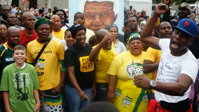 A group of mourners sing and dance outside Mandela's Johannesburg home on December 6.