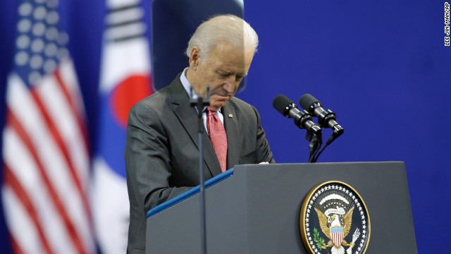 U.S. Vice President Joe Biden pays a silent tribute to Mandela before his speech at Yonsei University in Seoul, South Korea, on December 6.