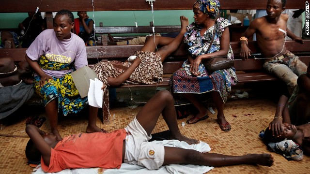 Civilians wait for treatment at Bangui's hospital after a daylong gun battle between Seleka soldiers and Christian militias on December 5. Christian vigilante groups have formed to battle Seleka, the predominantly Muslim coalition behind the March removal of President Francois Bozize.