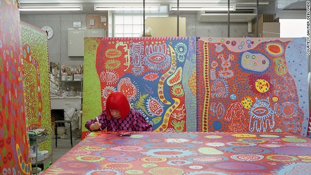 here Kusama is pictured working in her studio. The artist says the kaleidoscopic rooms are her attempt to investigate life, death and infinity.