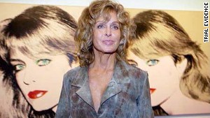 Farrah Fawcett posed with two Andy Warhol prints of her at the Warhol Museum in Pittsburgh.