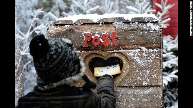 A child posts a letter to Santa in the Elf Village in Ascot, England, on November 30. LaplandUK opened its doors at its new location in Ascot, offering a Christmas experience set in a snow-covered forest with real huskies, reindeer and Father Christmas himself.