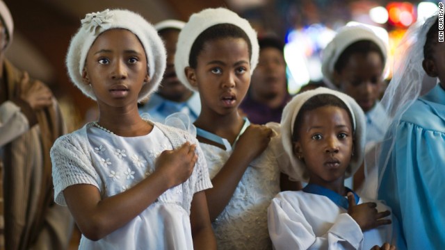 Young choir members attend a morning Mass on December 8 in memory of Mandela at the Regina Mundi Catholic Church, one of the focal points of the anti-apartheid struggle, in the Soweto district of Johannesburg. South Africans flocked to houses of worship for a national day of prayer and reflection to honor Mandela.