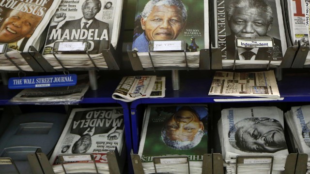 Newspapers with Mandela on the front page are on sale in London on December 6.