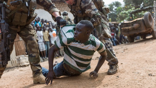 French soldiers arrest an alleged ex-Seleka rebel in a neighborhood near the airport in the capital of Bangui on December 9.