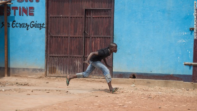 A man runs from a gunfire during a disarmament operation by French soldiers in Bangui on December 9. Violence has raged since a coalition of rebels deposed President Francois Bozize in March, the latest in a series of coups since the nation gained independence. Bozize fled after his ouster.