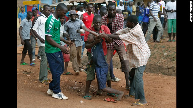 Mobs of Christians grab a child holding a knife in Bangui on December 9.