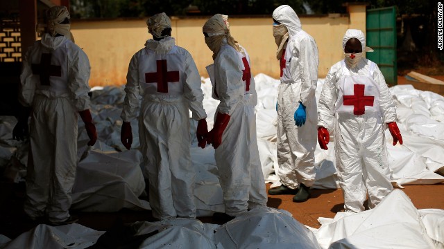 Red Cross employees stand amid dozens of bodies at the morgue in Bangui on December 8. The number of corpses delivered to a hospital morgue in the city rose Friday afternoon to 92, according to Doctors without Borders.