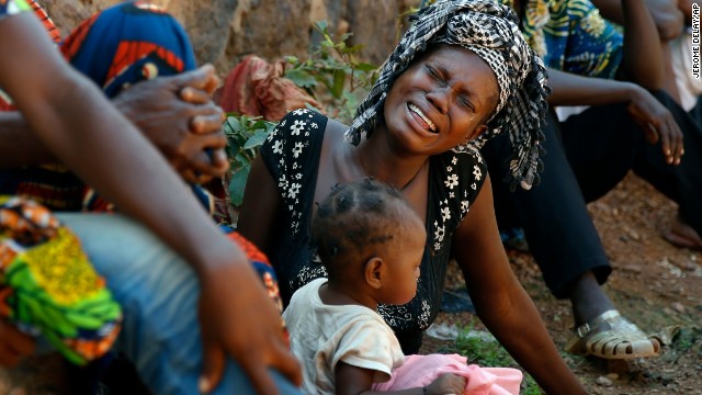 Relatives of Thierry Tresor Zumbeti, who died from bullet wounds to the neck and stomach, grieve outside his home in Bangui on Saturday, December 7.