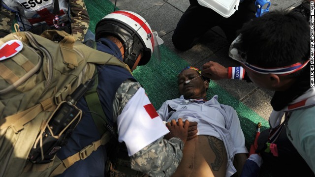 Rescuers treat a Thai anti-government protester after he fainted from exhaustion during a rally outside Government House in Bangkok on December 9.