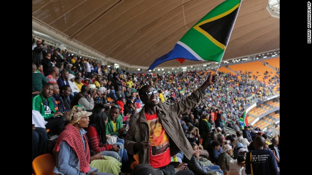 A man waves a South African flag at FNB Stadium.