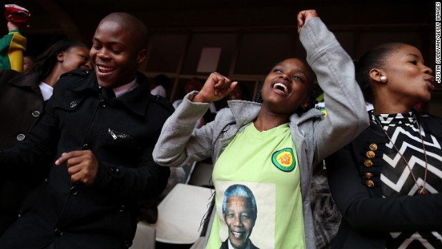 People celebrate Mandela at a telecast of the memorial service at Ellis Park in Johannesburg.