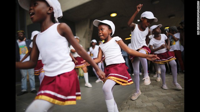 Girls dance during the memorial service at FNB stadium.