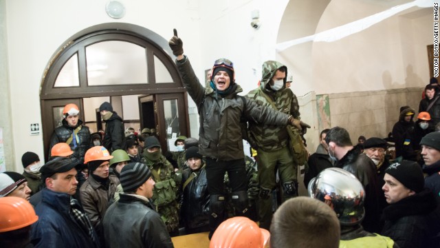 A protester calls for attention inside the City Hall after riot police were forced out from blocking the front door on December 11.