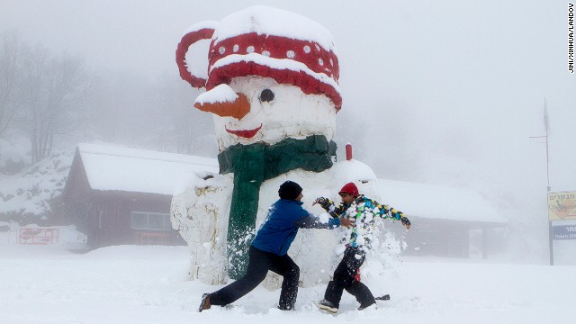 Israelis play next to a giant snowman on Mount Hermon in Golan Heights on December 11.