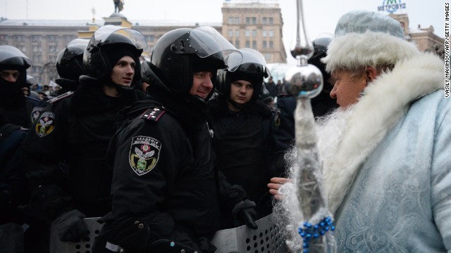 A man dressed as Santa Claus addresses riot police on Independence Square in Kiev, Ukraine, on Wednesday, December 11. 