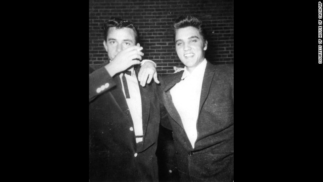 Cash, left, and Elvis Presley pose together in the 1950s.