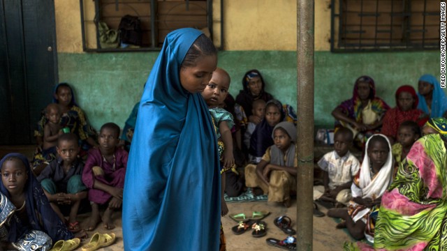 A young woman holds her baby at an elementary school in the Muslim district of Bangui on December 11.