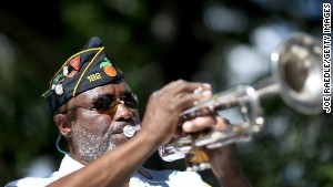 Cyril Bullard, retired from the U.S. Army, plays the trumpet at a Veterans Day ceremony last month in Florida.