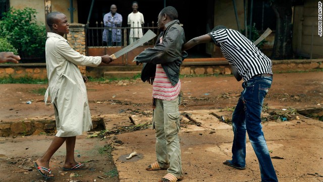 Muslim men rough up a Christian man while checking him for weapons on December 13 in Bangui.