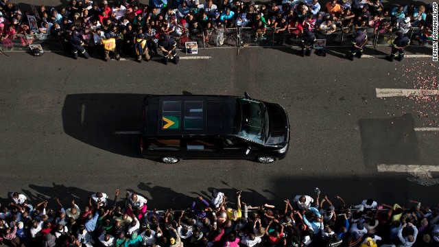 Mandela's funeral procession drives toward the Union Buildings on December 12. Each morning his remains were transported from the mortuary to the government buildings. 