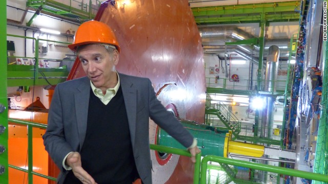 Joe Incandela, the spokesperson for CMS, says that about 4,000 scientists collaborate on the experiment. Behind him is a new red-colored layer to improve the detection of muons, which are fundamental particles