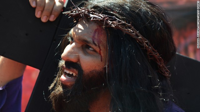 Indian Christian Alan D'Souza portrays Jesus as he carries a cross through a residential area on Good Friday in Mumbai on March 29. A procession of Indian Christians from all walks of life participated in the march portraying the suffering meted out by Roman soldiers to Jesus on his way to be crucified. 